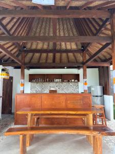 a wooden bench sitting in front of a bar at Puri Lepang Riverside in Ketewel
