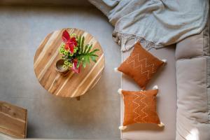 a table with a plate of cookies and a vase of flowers at Casa pumara loft in Kerobokan +17 photos