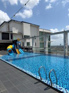 a swimming pool on the roof of a building at Tunjong Stay in Kota Bharu