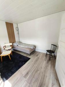 a room with a bed and a chair in it at JP Apartment Floor 1 in Grindsted