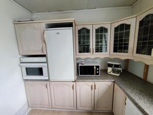 a kitchen with white cabinets and a white refrigerator at JP Apartment Floor 1 in Grindsted