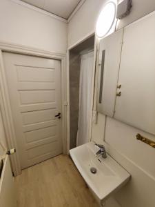 a bathroom with a white sink and a mirror at JP Apartment Floor 1 in Grindsted +2 photos