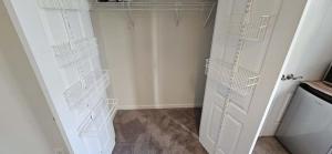 a white closet with white baskets on the wall at Single Room in Townhouse in Manassas