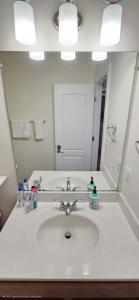 a bathroom with a sink and a large mirror at Single Room in Townhouse in Manassas