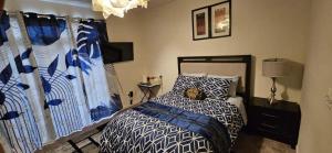 a bedroom with a bed with a blue and white comforter at Single Room in Townhouse in Manassas