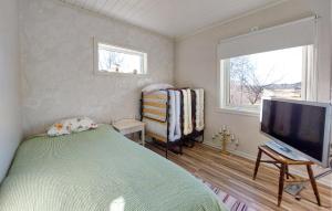 a bedroom with a bed and a flat screen tv at Amazing Home In Slättåkra in Slättåkra