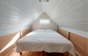 a bed in a small room with a window at Amazing Home In Slättåkra in Slättåkra
