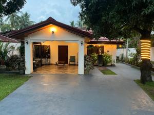a house with a porch and a patio at Leena Holiday Home in Batticaloa
