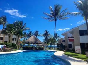 a pool at the resort with palm trees at Tropical Oasis with Pool Perfect Vacation Home in Puerto Morelos