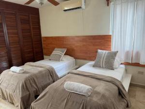a bedroom with two beds in a room at Tropical Oasis with Pool Perfect Vacation Home in Puerto Morelos