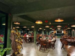 a group of people sitting at tables in a restaurant at Keeree at chiewlarn in Ban Tha Khun