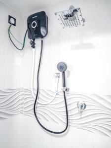 a bathroom with a shower with a camera on the wall at YK House Midigama in Midigama East