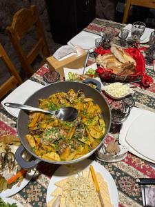a table with a large pan of food on it at Msho Amroc in Aparan