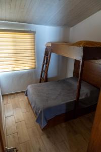 a bunk bed in a room with a ladder at Montepinar Acosta Suites in Mazamitla