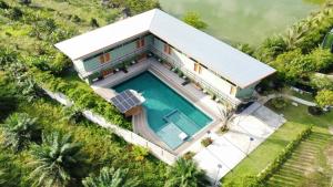 an aerial view of a house with a swimming pool at Keeree at chiewlarn in Ban Tha Khun +25 photos