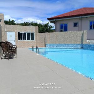 a swimming pool with a chair next to a house at Thyme residences condominium, Unit 208 in Cebu