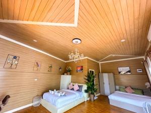 two beds in a room with a wooden ceiling at Cocoloco Pool Villa Ao Nang in Ao Nang  +52 photos