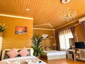 a hotel room with two beds and a chandelier at Cocoloco Pool Villa Ao Nang in Ao Nang 