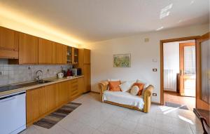 a kitchen with a couch in the middle of a room at Ca' Piero in Lamon
