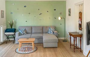 a living room with a couch and a table at 2 Bedroom Awesome Home In Faaborg in Faaborg