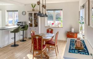 a kitchen and dining room with a table and chairs at 2 Bedroom Awesome Home In Faaborg in Faaborg