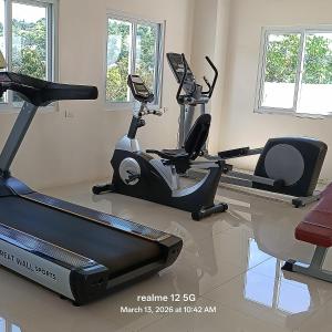 a gym with two exercise bikes and a treadmill at Thyme residences condominium, Unit 208 in Cebu