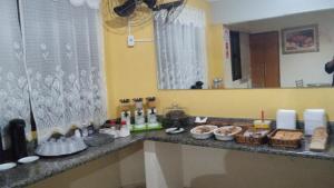 a counter top with food on it in a room at HOTEL CENTER Ribeirão in Ribeirão Preto
