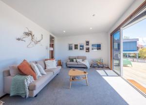 a living room with a couch and a table at Pohara's Beachside Bliss in Pohara