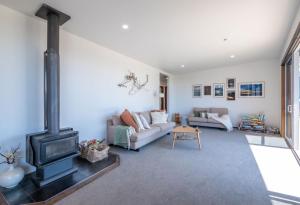 a living room with a couch and a fireplace at Pohara's Beachside Bliss in Pohara