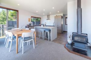 a kitchen and dining room with a table and a stove at Pohara's Beachside Bliss in Pohara