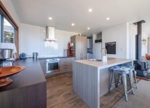 a kitchen with a large island with a sink at Pohara's Beachside Bliss in Pohara +9 photos