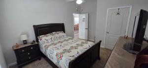 a bedroom with a bed and a dresser and a television at Spacious Private Room - Workspace - Las Cruces in Las Cruces
