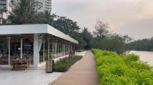 a walkway next to a building next to a river at Căn hộ cao cấp Diamond Island Luxury Apartment in Ho Chi Minh City