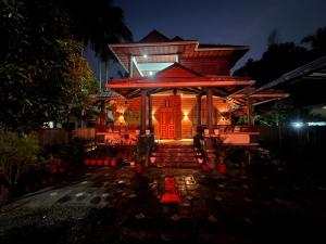 a house with a red door at night at Niramaya Heritage Homestay in Kottayam