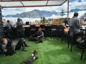 a group of people sitting in chairs on the grass at Cabanaconde Backpackers - Plaza de Armas in Cabanaconde +8 photos