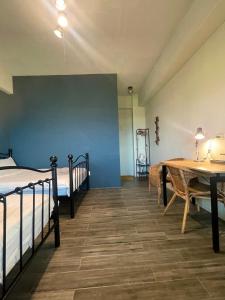 a room with two beds and a table and a table and a table at Lanyu IGANG Hotel in Lanyu