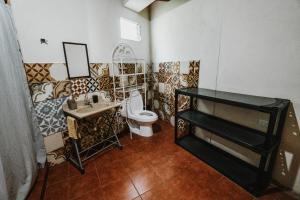 a bathroom with a toilet and a sink at Thermal Paradise Villa in Caluco +69 photos