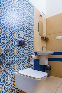 a bathroom with a toilet and a sink at Niramaya Heritage Homestay in Kottayam +51 photos