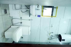 a bathroom with a toilet and a window at Hotel Pujari in Khātu