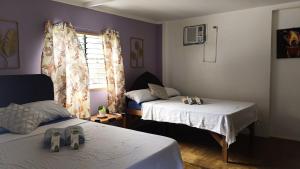 a bedroom with two beds with shoes on the beds at Hidden Paraiso Resort in Puerto Galera +12 photos