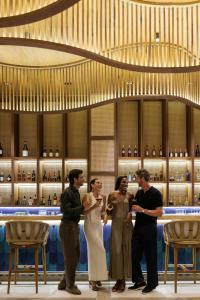 a group of people standing in front of a bar at Donoma Las Terrenas Resort & Villas, Autograph Collection in Las Terrenas +140 photos
