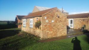 a brick house with a yard in front of it at Brampton Dales Farm in Gainsborough