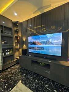 a living room with a large flat screen tv at EIMACK APARTMENT Service in Asaba +7 photos