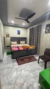 a bedroom with a large bed in a room at Sneham home stay in Vrindāvan