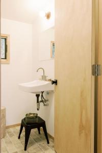 a bathroom with a sink and a white sink at Skogstead Cabin in the boreal forest in Fairbanks +59 photos