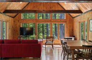 a living room with a red couch and a table at STARGAZER SHORES LIMIT 8 villa in Bridgton