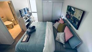 a bedroom with a bed with pillows on it at Urba Residences in Auckland