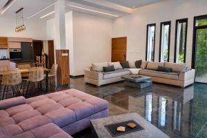 a living room with a couch and a table at Villa de luxe piscine chauffée & Jacuzzi & Petit déjeuner in Fez