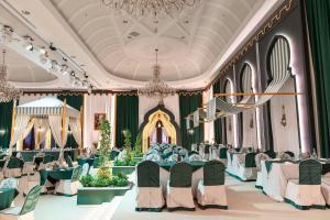 a banquet hall with tables and chairs and a chandelier at The Ritz-Carlton, Doha in Doha +186 photos