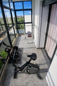 a room with a gym with windows at Villa de luxe piscine chauffée & Jacuzzi & Petit déjeuner in Fez